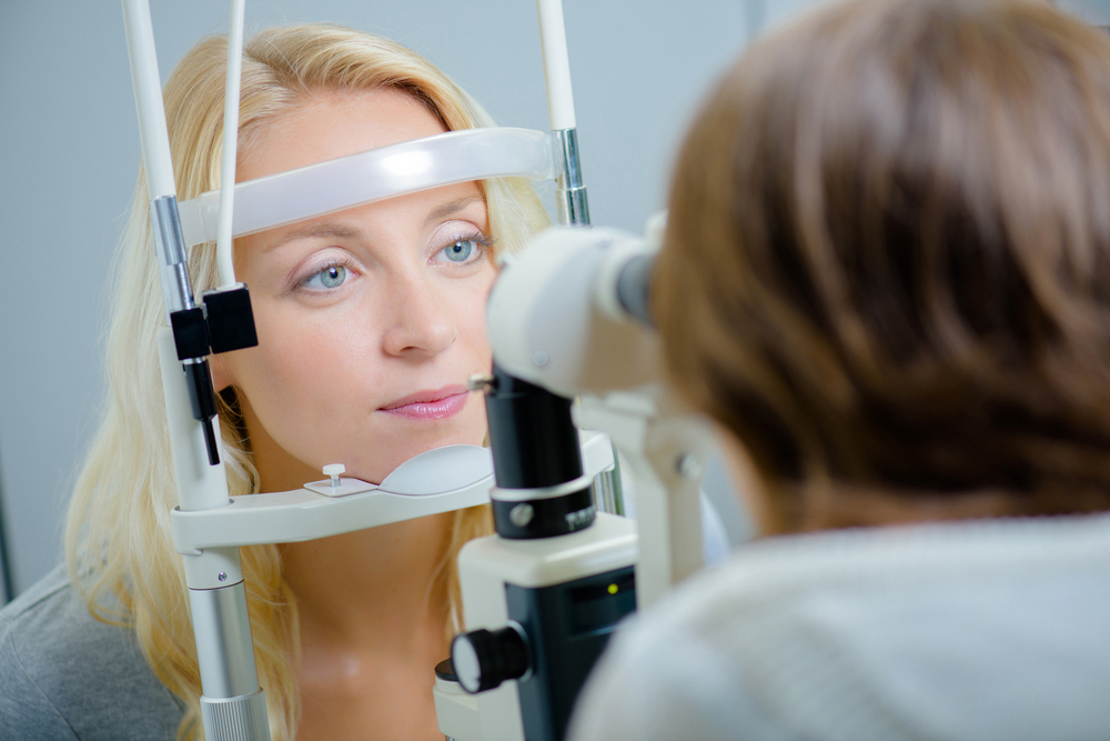 woman receiving an eye exam from her optometrist